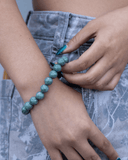 Person wearing a green beaded  jade bracelet
