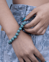 Person wearing a green beaded  jade bracelet
