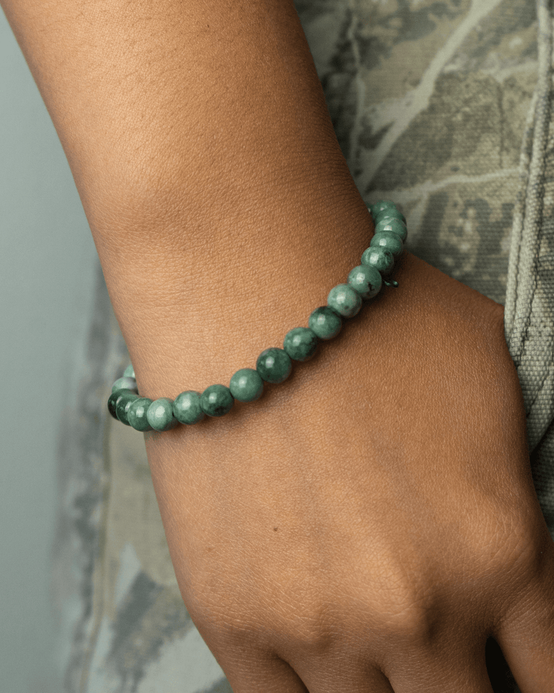 Small green beaded jade bracelet on a wrist